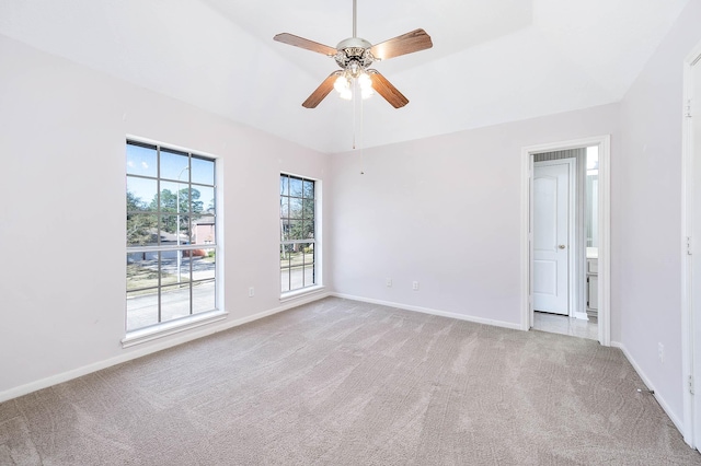 empty room with ceiling fan, light carpet, and plenty of natural light