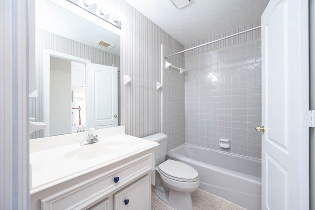 full bathroom with a textured ceiling, tile patterned flooring, toilet, vanity, and tiled shower / bath combo