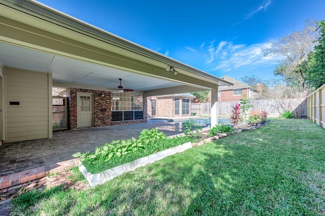 view of yard with a patio area and ceiling fan