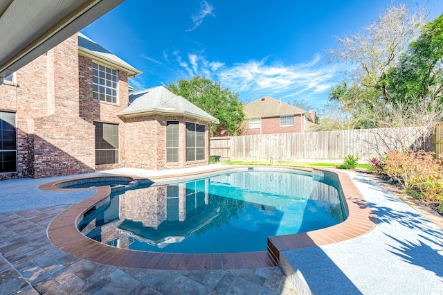 view of swimming pool featuring an in ground hot tub