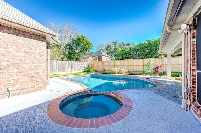 view of swimming pool featuring a patio area and an in ground hot tub