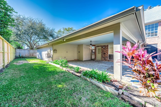 rear view of house with a patio area, ceiling fan, and a yard