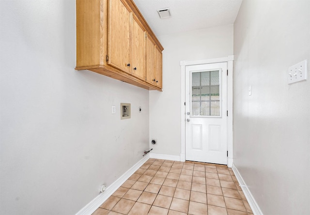 washroom with light tile patterned floors, electric dryer hookup, hookup for a washing machine, cabinets, and gas dryer hookup