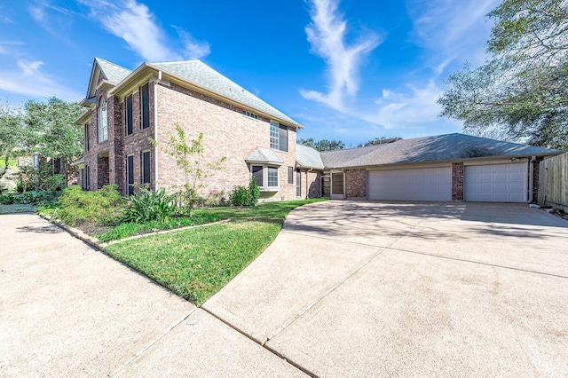 view of front of house with a front yard and a garage