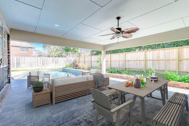 view of patio / terrace with ceiling fan, a fenced in pool, and an outdoor living space