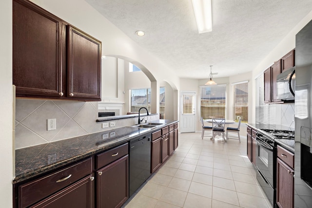 kitchen with black appliances, pendant lighting, a textured ceiling, and sink