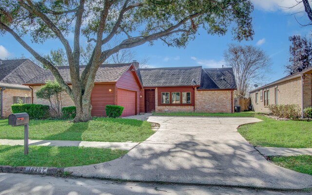 single story home with a garage and a front lawn