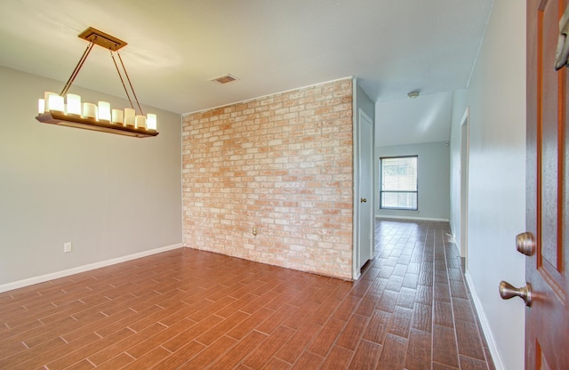 spare room with brick wall