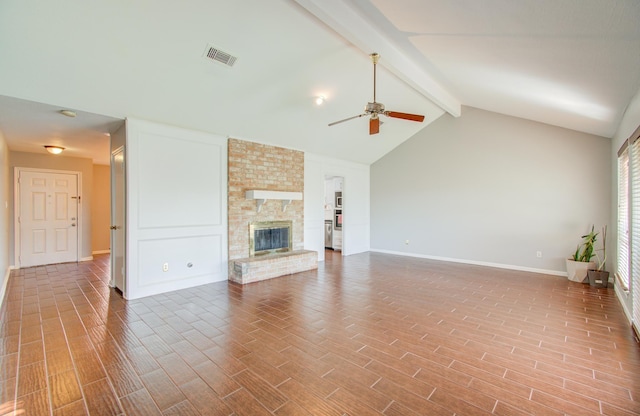 unfurnished living room featuring ceiling fan, a fireplace, high vaulted ceiling, and beamed ceiling