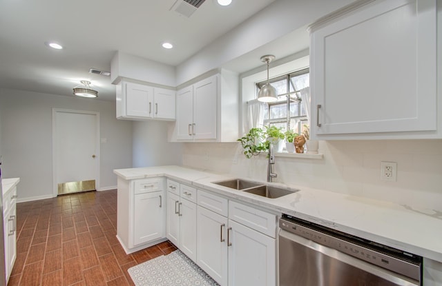 kitchen featuring dishwasher, sink, and white cabinets