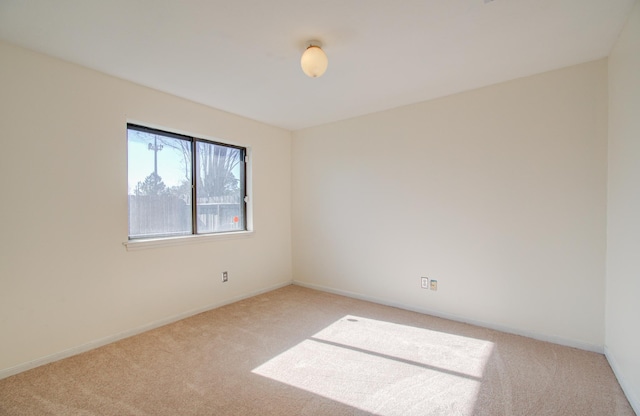 unfurnished room featuring light colored carpet