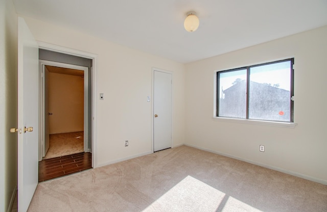 unfurnished bedroom featuring light carpet