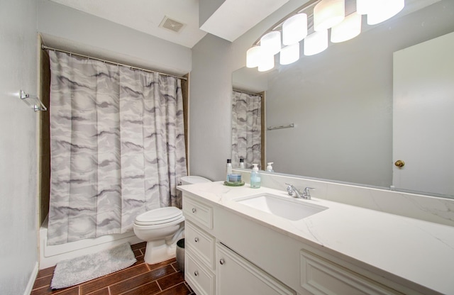 full bathroom with vanity, shower / tub combo with curtain, and toilet