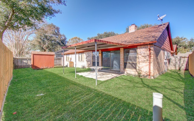 back of house with a shed, a lawn, and a patio