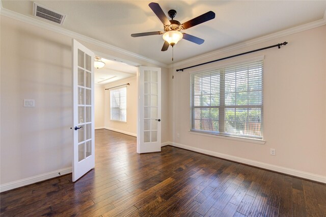 empty room featuring ornamental molding, dark wood-type flooring, ceiling fan, and french doors