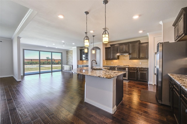 kitchen with tasteful backsplash, dark brown cabinets, open floor plan, ornamental molding, and stainless steel appliances