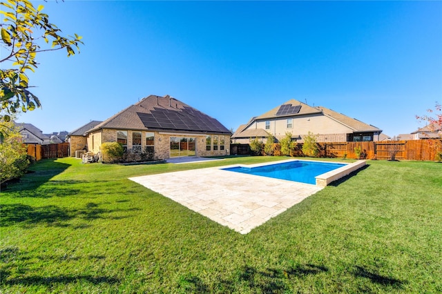 view of pool with a lawn, a fenced backyard, and a patio area