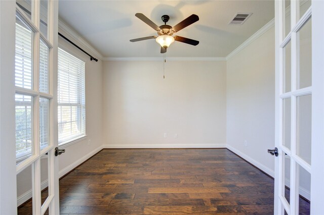 spare room featuring ceiling fan, plenty of natural light, ornamental molding, and dark hardwood / wood-style flooring