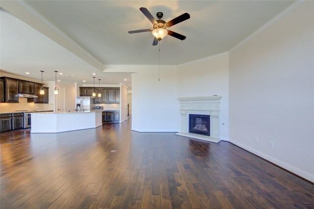 unfurnished living room with crown molding, dark hardwood / wood-style floors, and ceiling fan