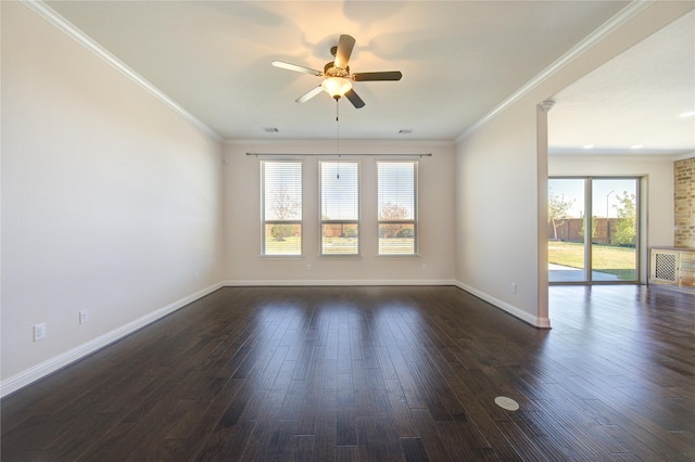 spare room with crown molding, a ceiling fan, baseboards, and dark wood-type flooring