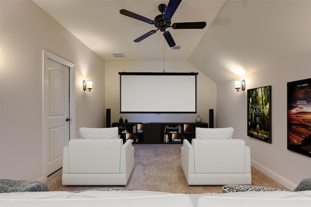 home theater room featuring carpet floors, ceiling fan, visible vents, and vaulted ceiling