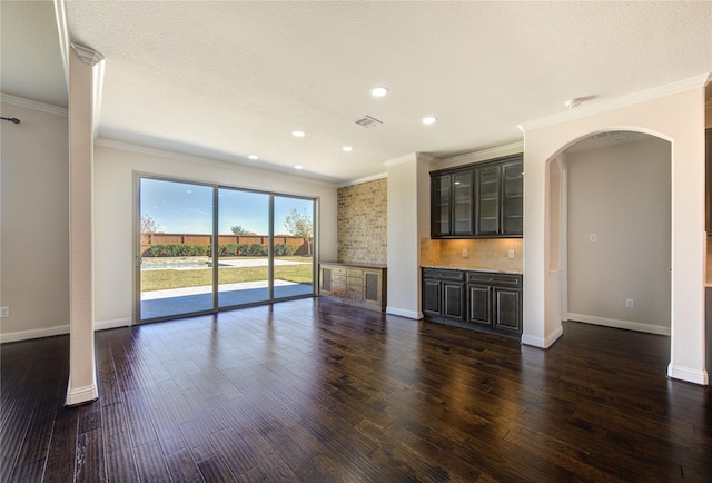 6611 Hollow Bay Ct, Katy, TX 77493 - unfurnished living room with arched walkways, crown molding, dark wood-style floors, baseboards, and recessed lighting