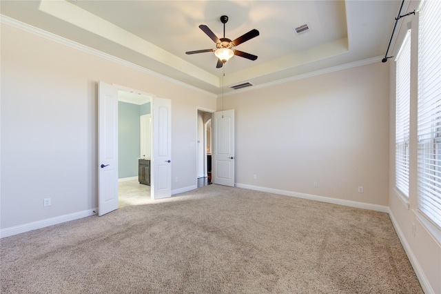 6611 Hollow Bay Ct, Katy, TX 77493 - unfurnished bedroom with a tray ceiling, light colored carpet, crown molding, baseboards, and a ceiling fan