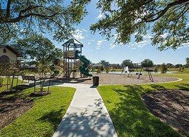 surrounding community with a yard and playground community
