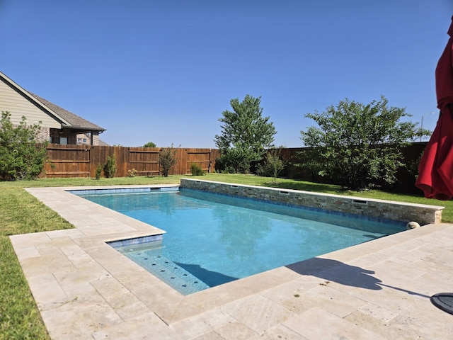 view of swimming pool with a lawn, a patio, a fenced in pool, and a fenced backyard