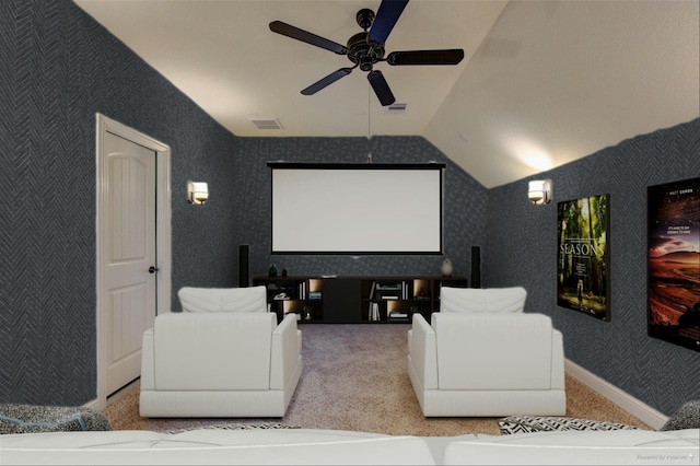carpeted home theater with ceiling fan, visible vents, and lofted ceiling