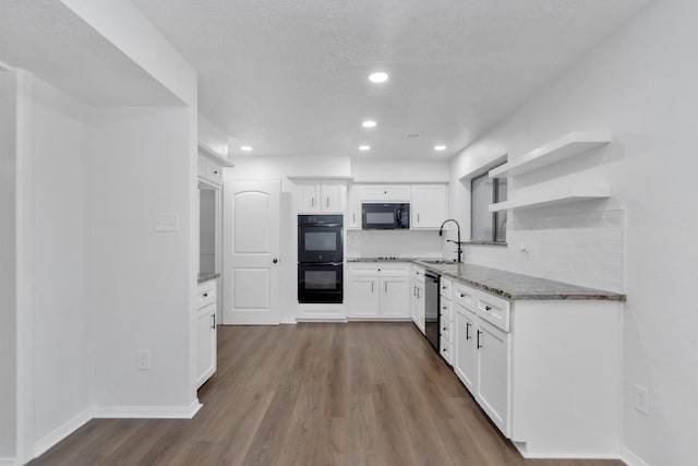 kitchen with backsplash, black appliances, dark wood-type flooring, and white cabinets