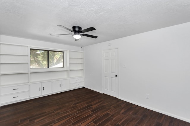 unfurnished bedroom featuring ceiling fan, dark wood-type flooring, and a textured ceiling