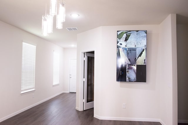 empty room with dark wood-type flooring