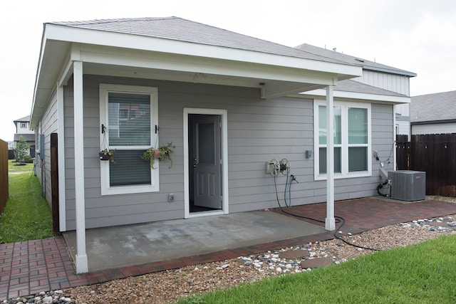 back of house with central AC and a patio