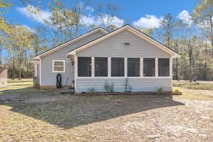 view of front facade featuring a front yard and a sunroom