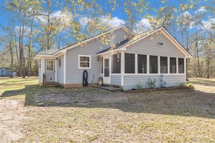 view of front of house with a sunroom and a front lawn