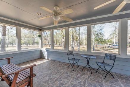 sunroom / solarium with ceiling fan and a wealth of natural light