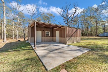 view of outbuilding featuring a lawn