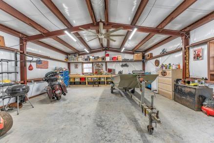 garage with ceiling fan and a workshop area