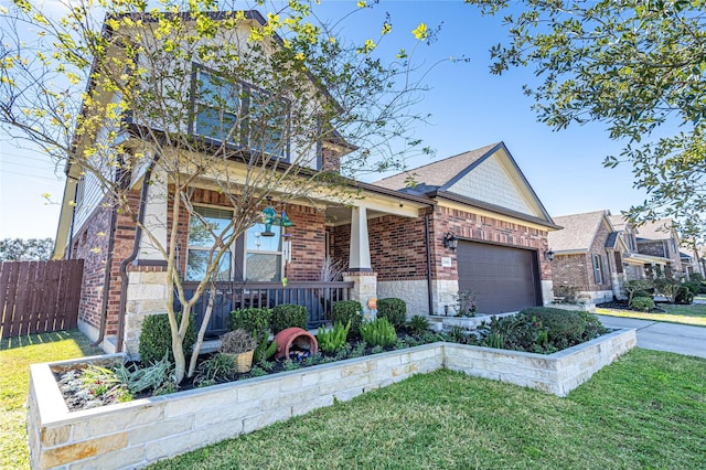 view of front of property with a front yard, covered porch, and a garage