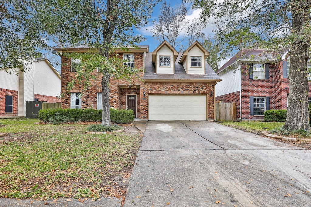 view of property with a front yard and a garage