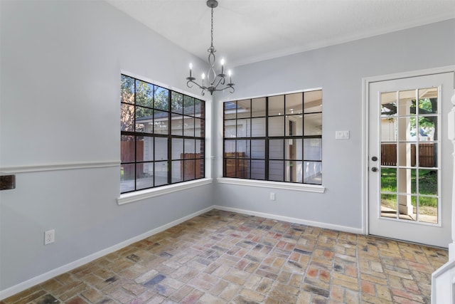 unfurnished dining area featuring a chandelier