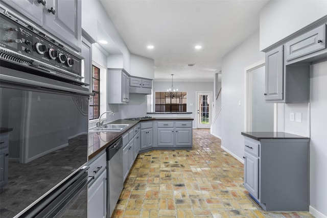 kitchen featuring sink, hanging light fixtures, black appliances, and gray cabinetry