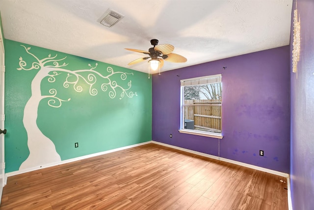 spare room featuring ceiling fan and hardwood / wood-style floors