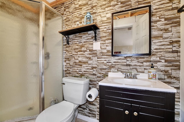 bathroom featuring an enclosed shower, vanity, and toilet