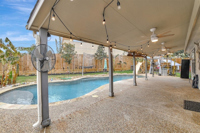 view of pool with ceiling fan and a patio