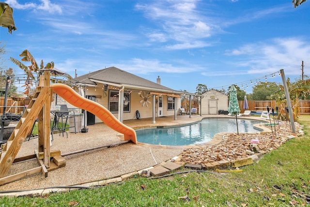 view of pool with a playground, a patio area, and a water slide