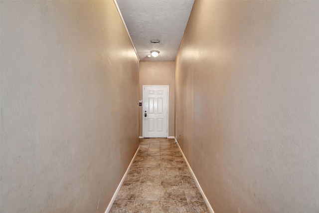 hallway featuring a textured ceiling