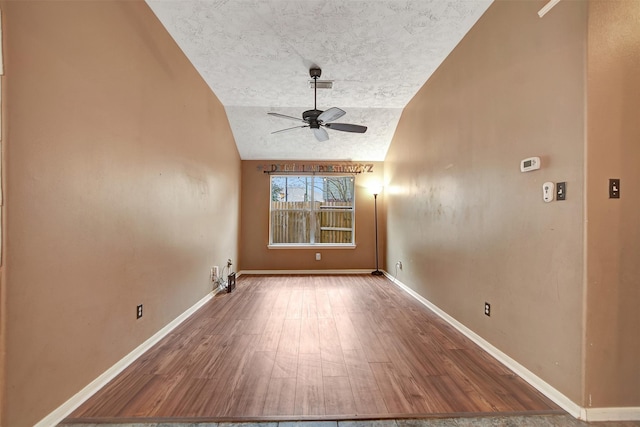 spare room with ceiling fan, hardwood / wood-style floors, and vaulted ceiling