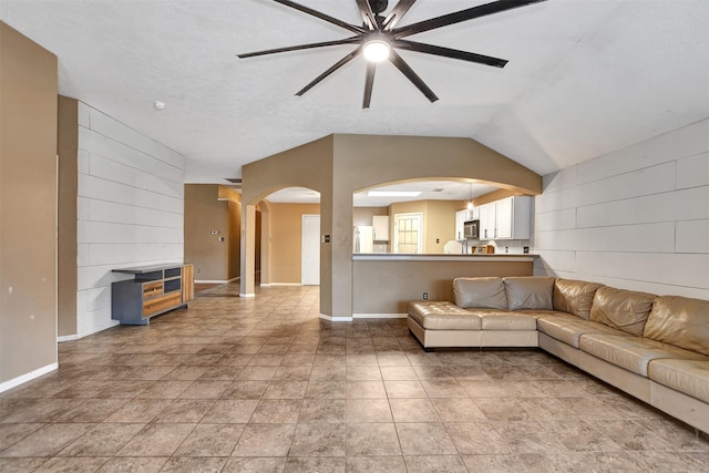 living room with ceiling fan and vaulted ceiling